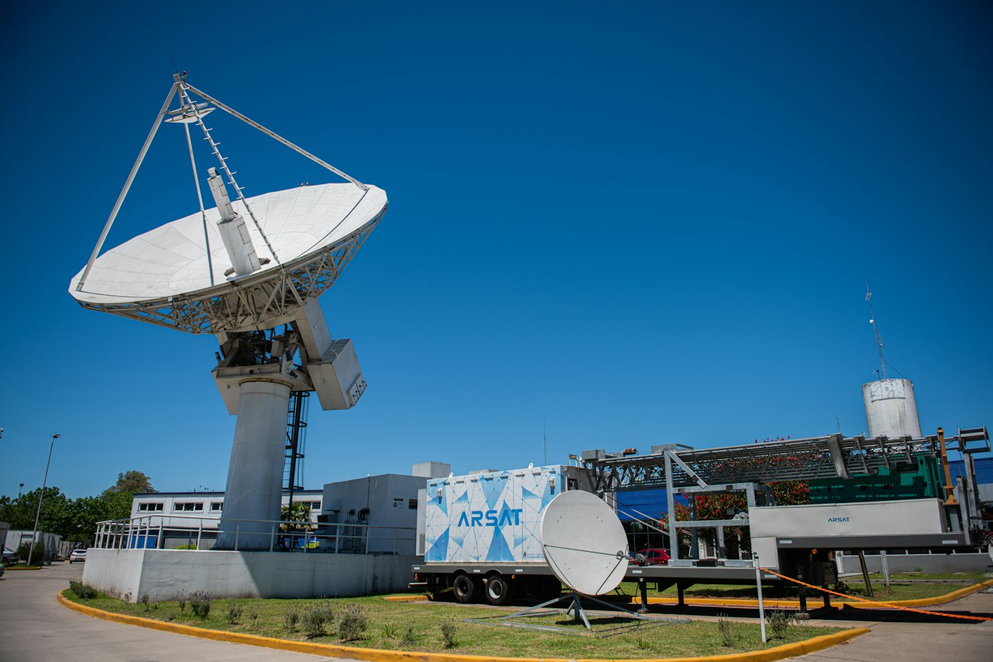 Large satellite dish and ARSAT truck at ground station.